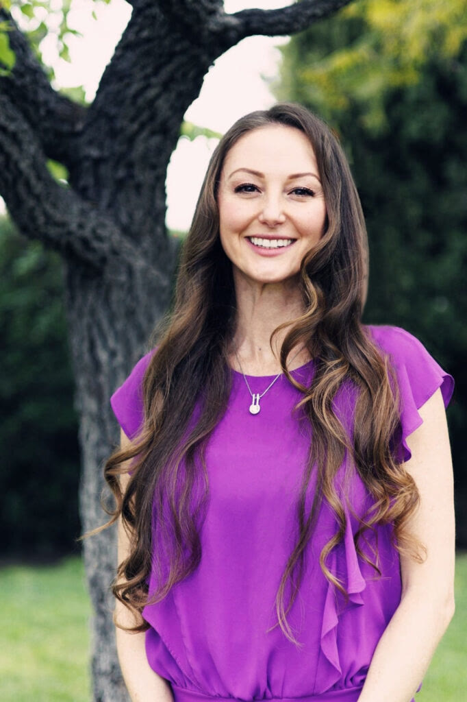 Natalie Tan, private yoga instructor in Orange County, smiling outdoors.